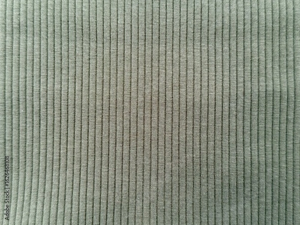 Fototapeta Close-up of green shirt fabric with fine weave and soft texture. Natural fibers, pale green color. T-shirt design, fresh, detailed background for fashion, textiles, and apparel design