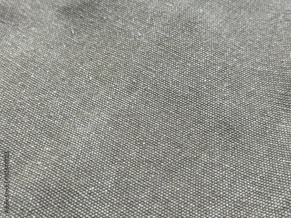 Fototapeta Horizontal close-up of grey t-shirt fabric with detailed woven texture. Soft, natural gray fibers, neutral background pattern. Wallpaper design for textile and fashion close up