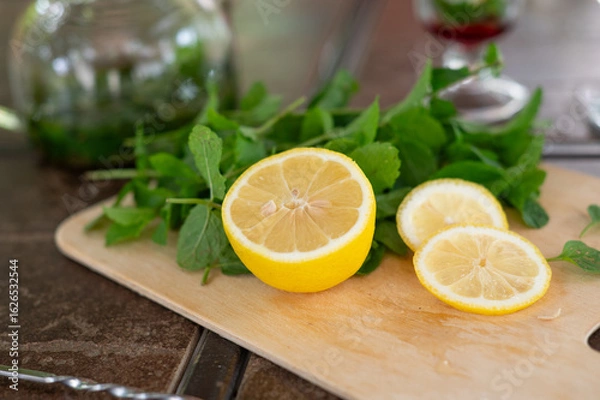 Fototapeta Ingredients for making a mojito at home. Lemon, mint, two glasses with syrup. summer. a refreshing drink