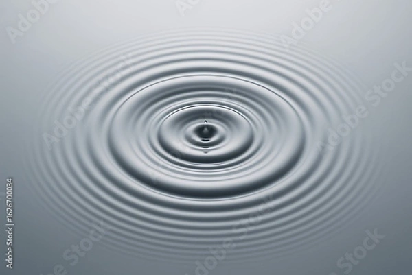 Fototapeta Concentric ripples expanding outward on a smooth water surface