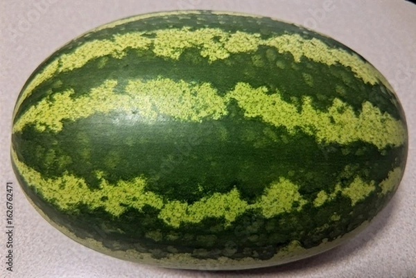 Fototapeta Whole and slice of ripe watermelon, heap of watermelon slices as background