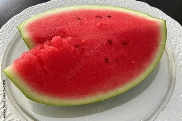 Fototapeta Whole and slice of ripe watermelon, heap of watermelon slices as background