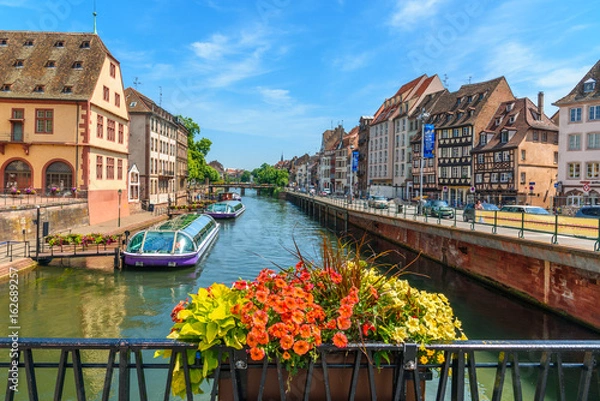 Fototapeta View of a canal of strasbourg with tourist boats