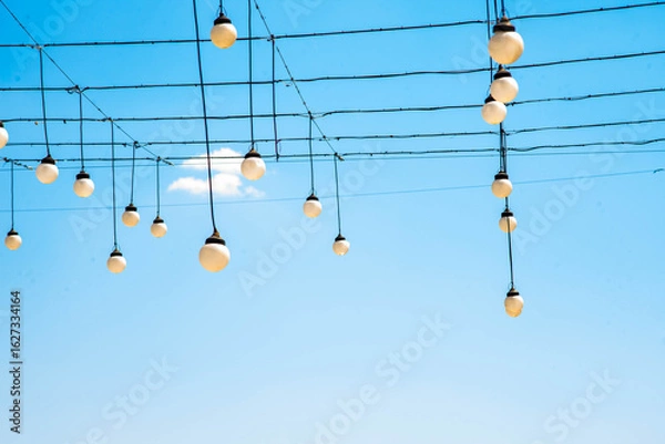 Fototapeta Flashlights with different colours in the town park