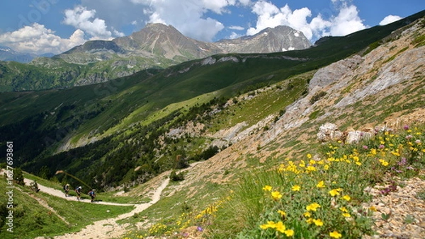 Obraz A hiking trail leading to La Turra and overlooking the Maurienne Valley and the village Aussois, Savoie, Northern French Alps, France, with the summit pointe de Bellecote in the background