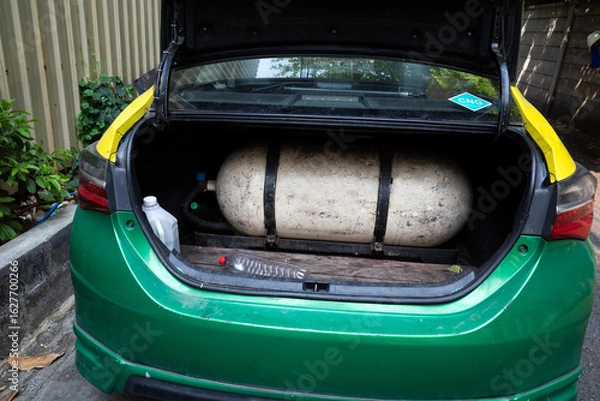 Fototapeta A taxi with a Compressed natural gas (CNG) tank installed in the boot of the car as alternate fuel