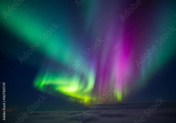 Fototapeta Stunning aurora borealis dances across night sky