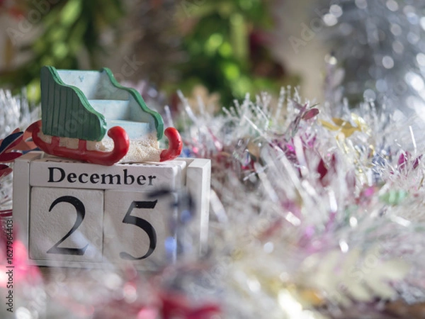 Fototapeta Santa's sleigh is placed on block date dated 25 December  waiting for fun festival Christmas and Happy New Year to make greeting card.