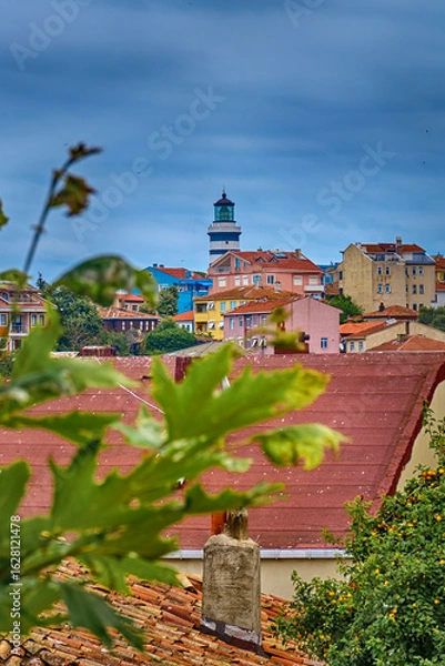 Fototapeta Lighthouse and colorful streets in Sile