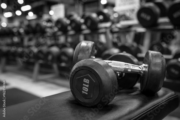 Fototapeta Black and white images dumbbell in the gym bodybuilding.