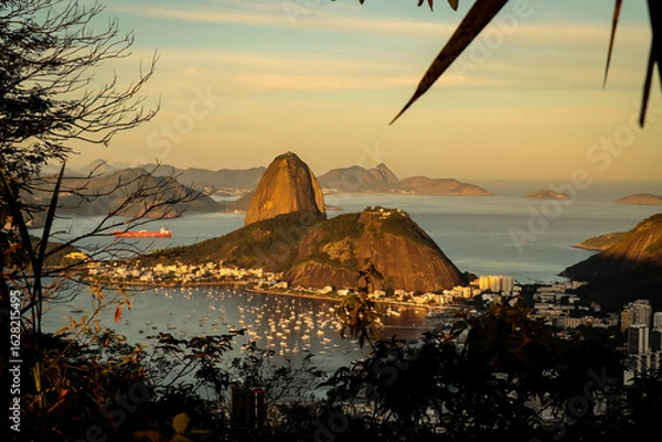 Fototapeta Rio de Janeiro, RJ, Brazil, 08/03/2025 - Sugar Loaf and Urca hills and Botafogo cove at sunset, seen from the Dona Marta viewpoint