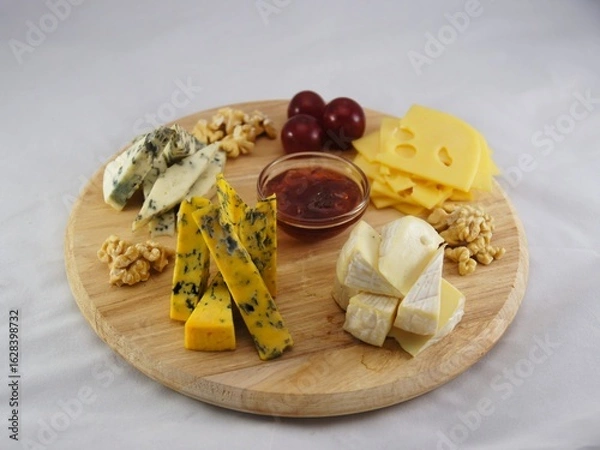 Fototapeta Charcuterie board with different types of cheese