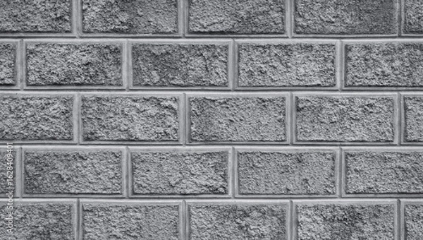 Fototapeta The weathered bricks wall with stucco and rough surface. Decorative grungy background or backdrop.