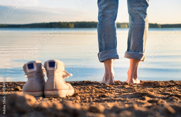 Obraz Man standing in beach at nice summer evening in Finland.
