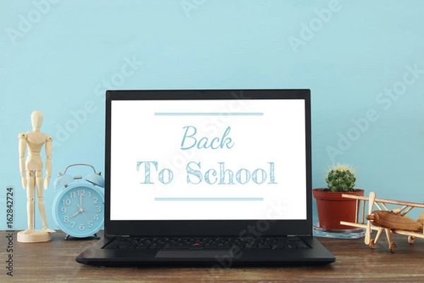 Fototapeta office work place with open leptop and empty white screen for copy space