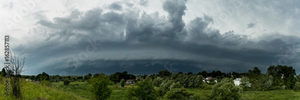 Obraz Supercell thunderstorm in the village, panorama of the storm clouds
