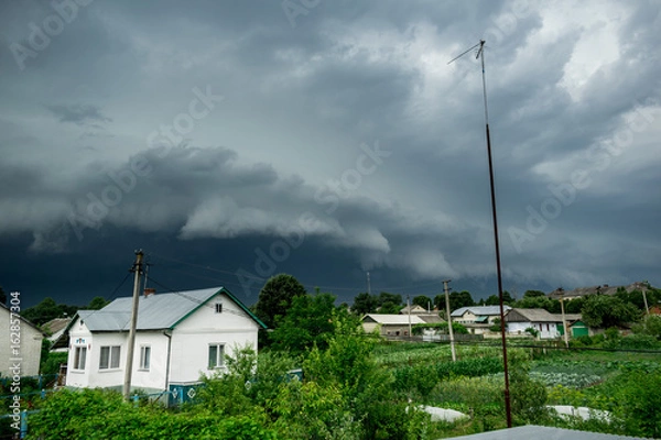 Obraz Approaching supercell thunderstorm in the village, squall line, storm clouds