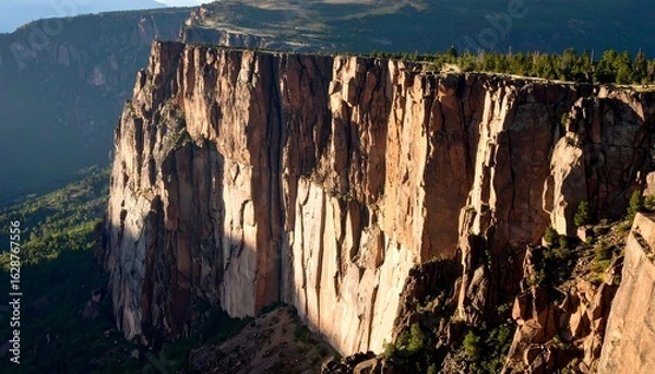 Fototapeta Cliff Face Rocky Landscape with Green Trees in Sunlight