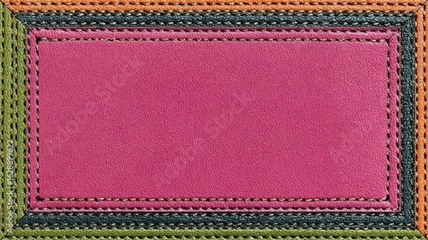 Fototapeta A rectangular pink leather patch is framed by a layered border of stitched greens, teal, orange, and yellow