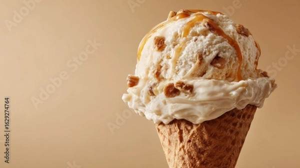 Fototapeta A delicious scoop of caramel ice cream rests in a waffle cone, highlighting its creamy texture and rich flavor. The warm brown background enhances the treat's appeal.