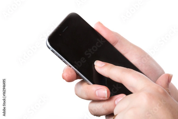Fototapeta Female hand holding modern black mobile smart phone with blank screen isolated on a white background