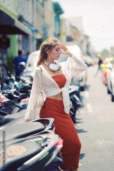 Obraz A beautiful teenage model girl posing on the streets of old town during street style photo shooting