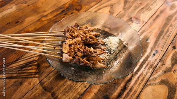 Obraz Appetizing cooked taichan beef satay, served on a clear glass plate, ready to eat