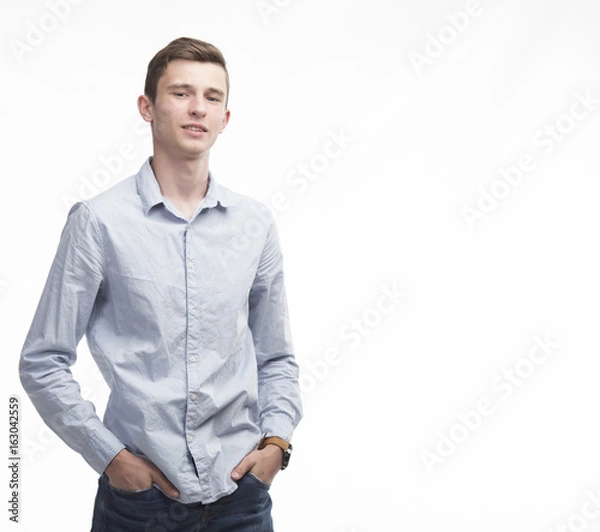 Fototapeta Young sexy man portrait of a confident businessman showing presentation on a gray background. Ideal for banners, registration forms, presentation, landings, presenting concept.