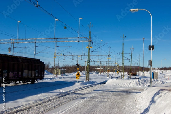 Fototapeta railway path in snow winter clear sky day