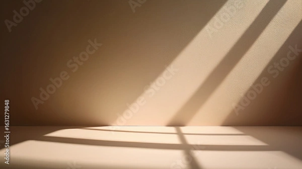 Fototapeta Sunlight creating palm leaf shadows on warm beige wall. Clean and cozy background.