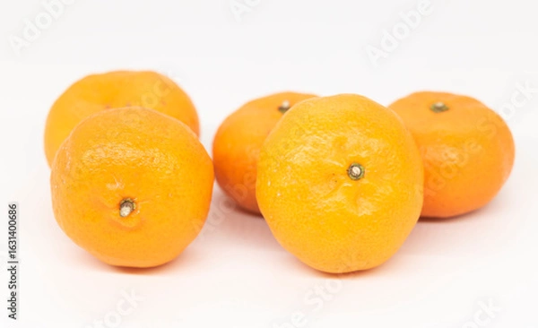 Fototapeta Fresh Citrus or tangerina and peeled fruit on white background