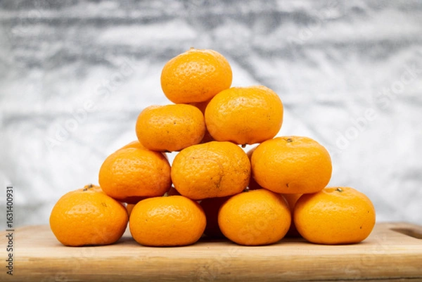 Fototapeta Group of Ripe Orange or Citrus or tangerina and peeled fruit With clipping path. Full depth of field