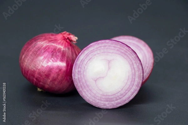 Fototapeta whole and slice Onion, isolated on black background.