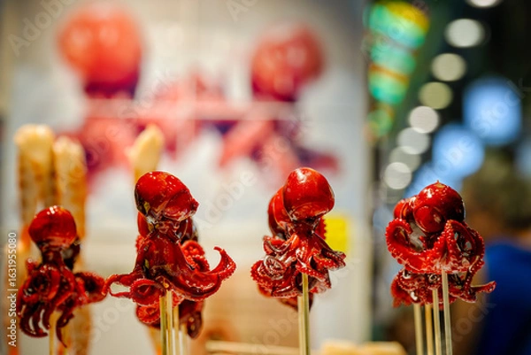 Fototapeta Delicious little lacquered octopuses at Nishiki Market, Kyōto, Japan. Umami, or savoriness, is one of the five basic tastes. Japanese street food.