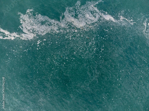 Obraz Wonderful tropical beach with blue water and orange sand forming small waves seen from above