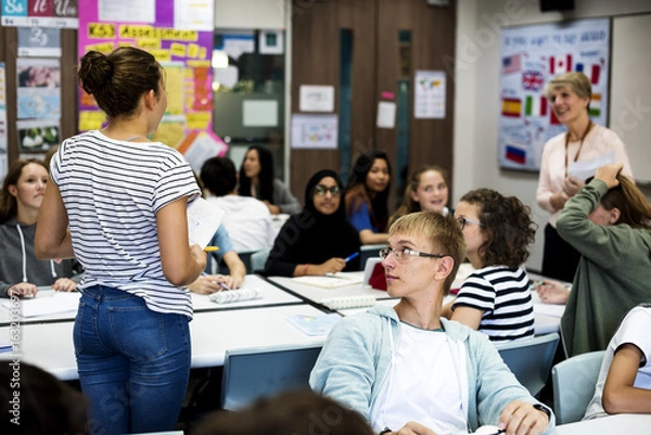 Fototapeta Group of students learning in classroom
