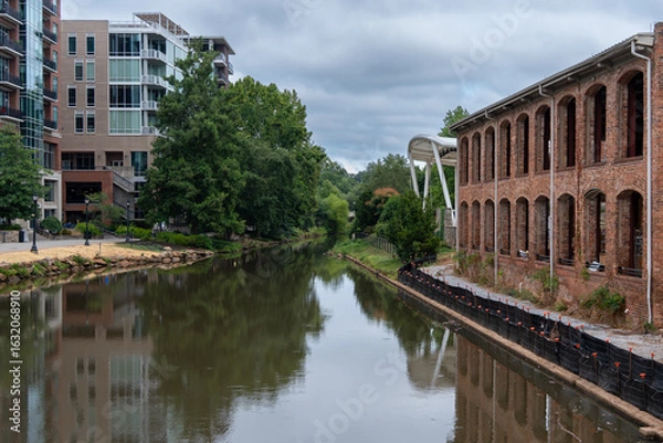 Fototapeta A Reedy River runs through Greenville SC with a brick building on the right