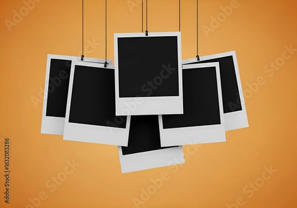 Fototapeta A cluster of blank instant photographs hanging against a warm orange background