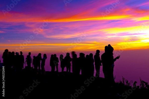 Fototapeta Group of people on top of a mountain waiting for take photo with light Twilight.