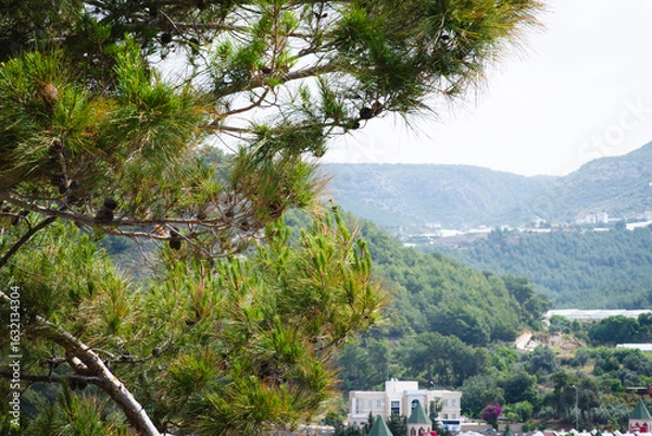 Fototapeta Stunning view of Calella de Palafrugell's pristine coastline featuring traditional whitewashed Mediterranean architecture, crystal-clear turquoise waters, and dramatic rocky outcrops along Costa Brava
