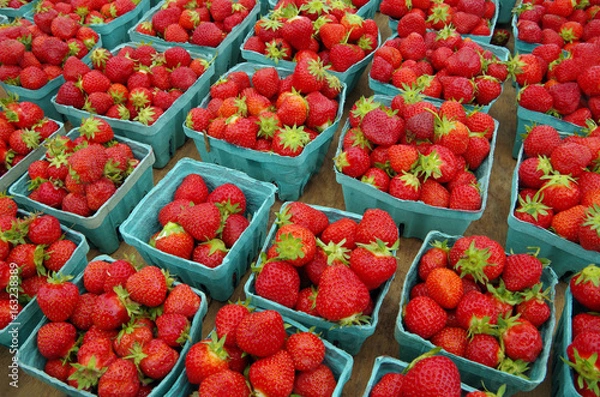 Fototapeta Strawberries displayed in baskets for market on wooden table