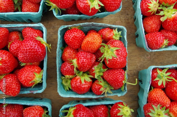 Fototapeta Strawberries displayed in baskets for market on wooden table