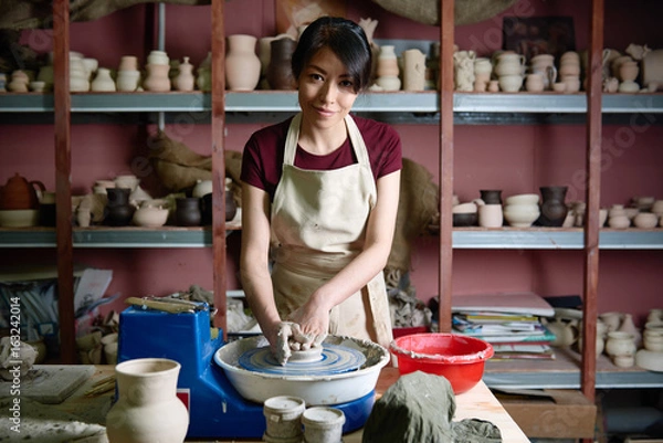 Obraz Young potter working on a potter's wheel