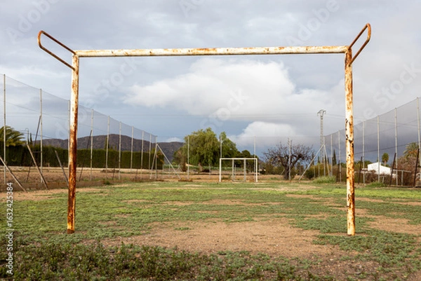 Obraz Old abandoned soccer field with rusty goalposts.