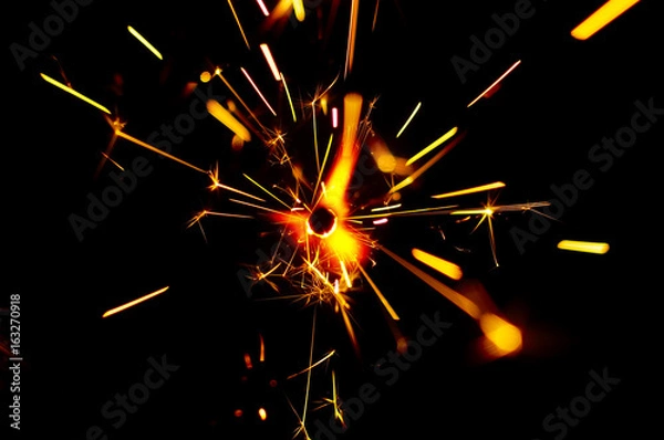 Obraz Fire Sparks With Motion Blur Effect Over Black Background
