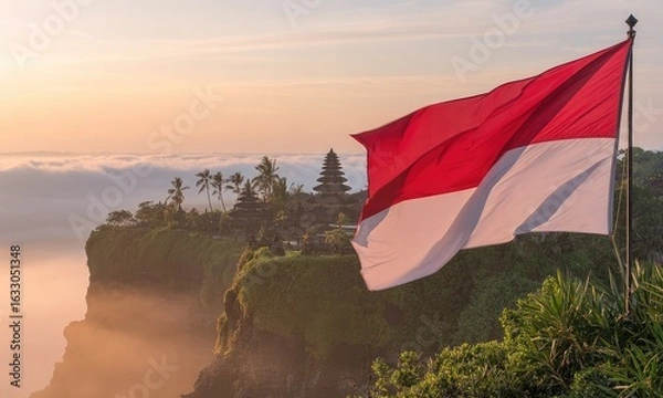Obraz Sunrise over cliffside temple with indonesian flag