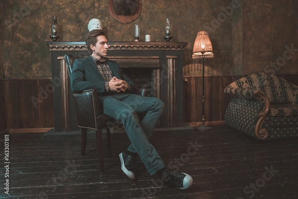 Obraz  Portrait of a businessman who sits by the fireplace with a pensive look