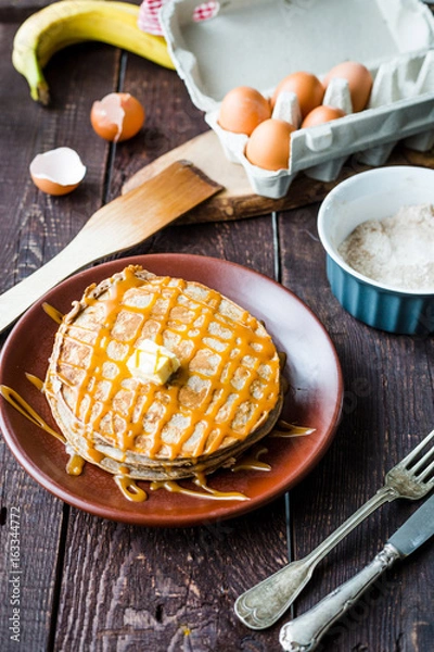 Fototapeta Healthy Banana Pancakes with Bananas and Salted Caramel Sauce, Vertical View