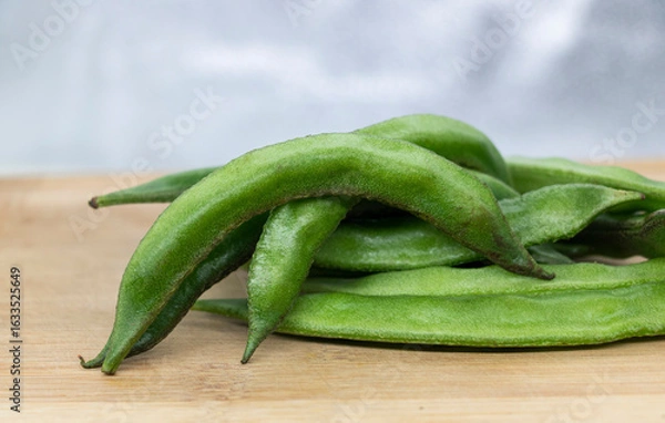 Fototapeta Close up of a wooden crate filled with broad beans.
