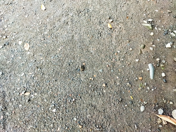 Fototapeta Gravel surface on country road. A dirt road in the countryside. Small stone road floor texture for background
